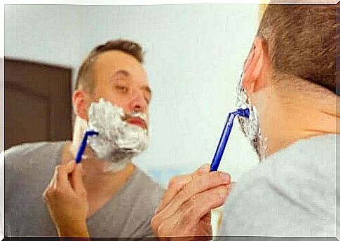 Man shaves with disposable razor