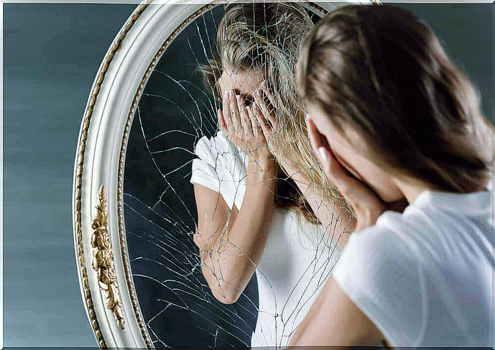 Woman by a broken mirror
