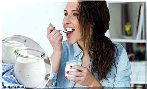 A woman eats yogurt